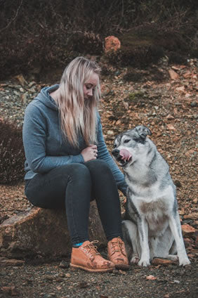 Woman with her dog enjoying nature and relaxation 
