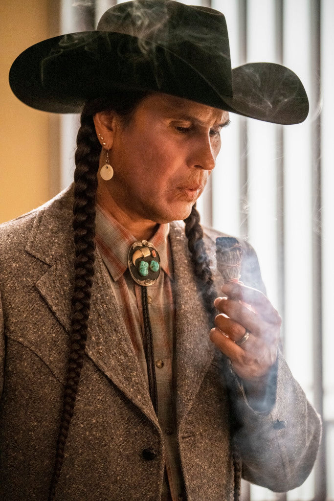 Native American Man Blowing On A Sage Smudge Stick