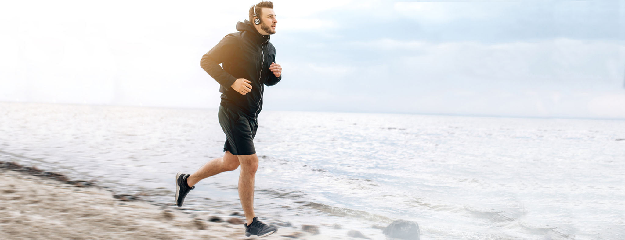 Men running on the beach 