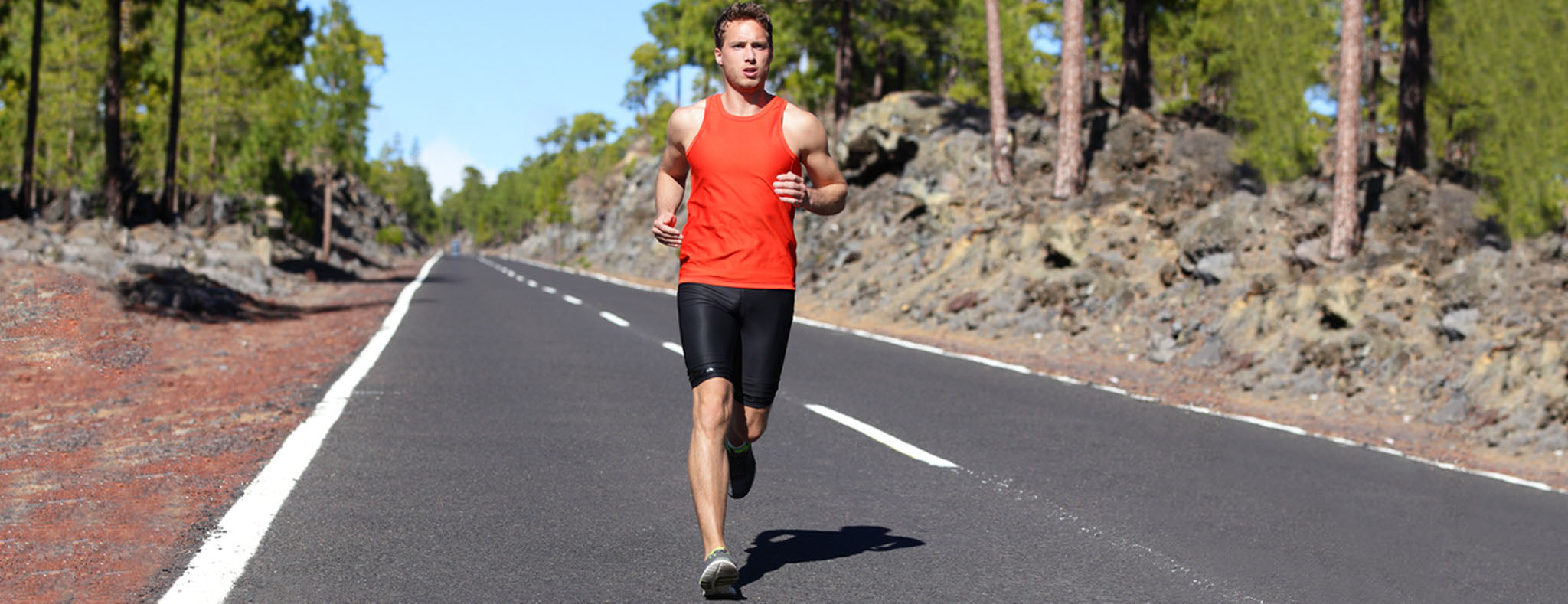 Men running outdoor in orange tank top