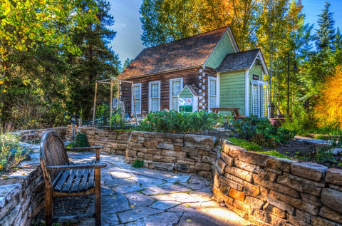 Small cabin house with beautiful garden outside and a patio