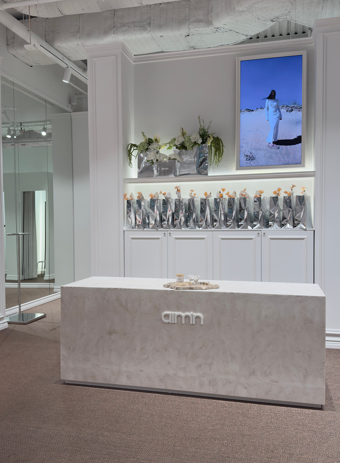 Image of aim’n’s store in Mall of Scandinavia with modern and bright interior, showing products and store details.