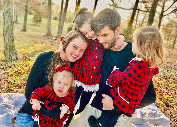 Author, Kaitlin Domangue hugging her family: three daughters and husband