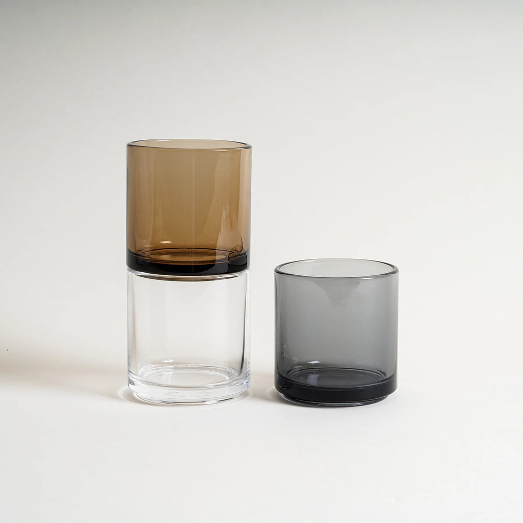 Hasami Porcelain Glass Tumbler in Amber, Clear, and Gray on a white seamless background