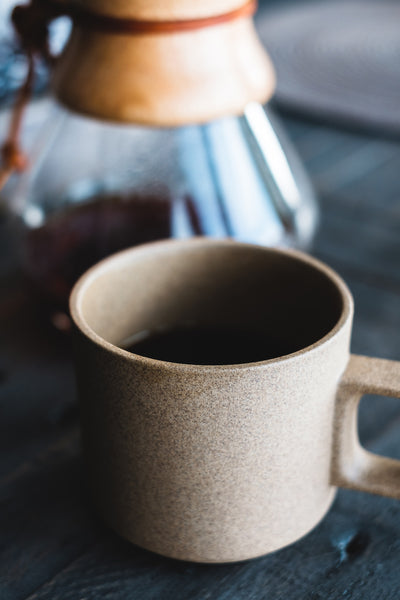 Hasami mug in natural with a coffee dripper on a table.