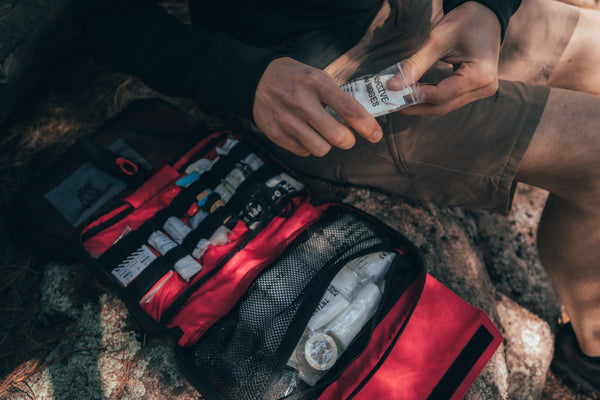 Person using first aid kit from the Companion Pack