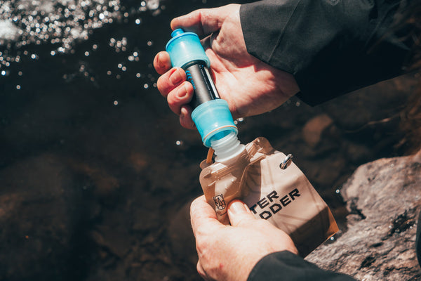 Using a water filter to filter water from a mountain stream