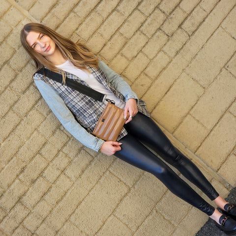 Sophie mixes textures with her denim & plaid shirt paired with faux leather pants