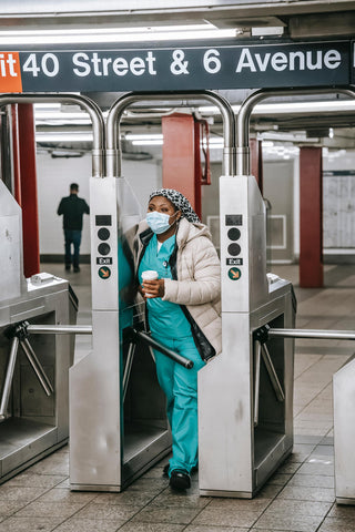 Nurse drinking coffee in the subway going to work to increase energy and focus