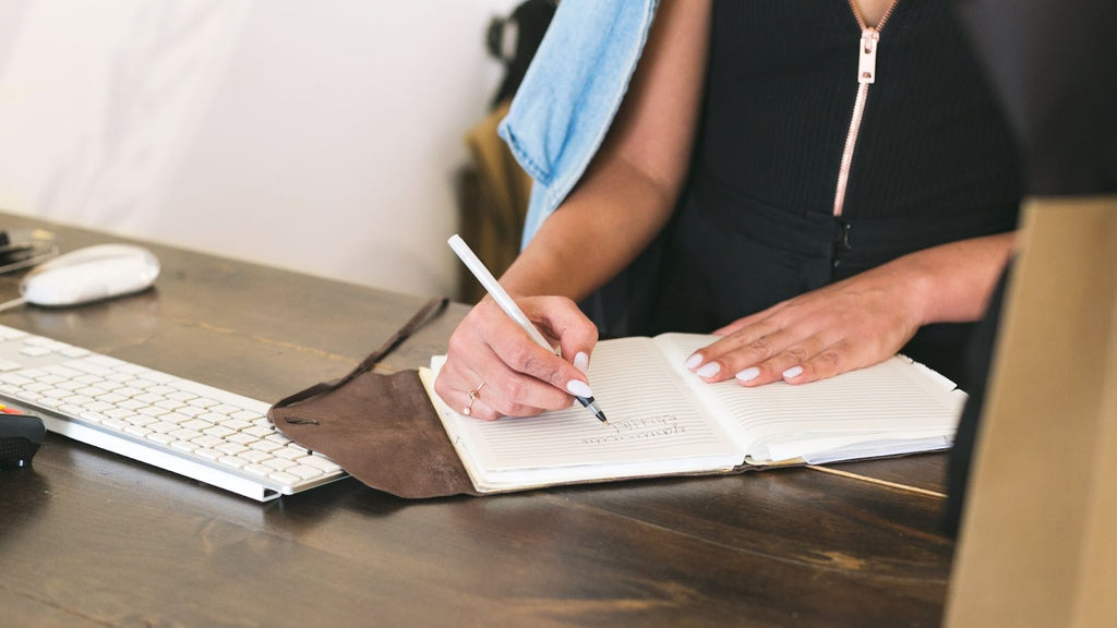 Woman writing on a notebook