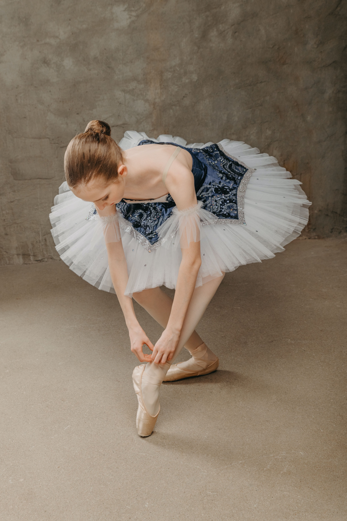 woman in a white tutu and ballet shoes