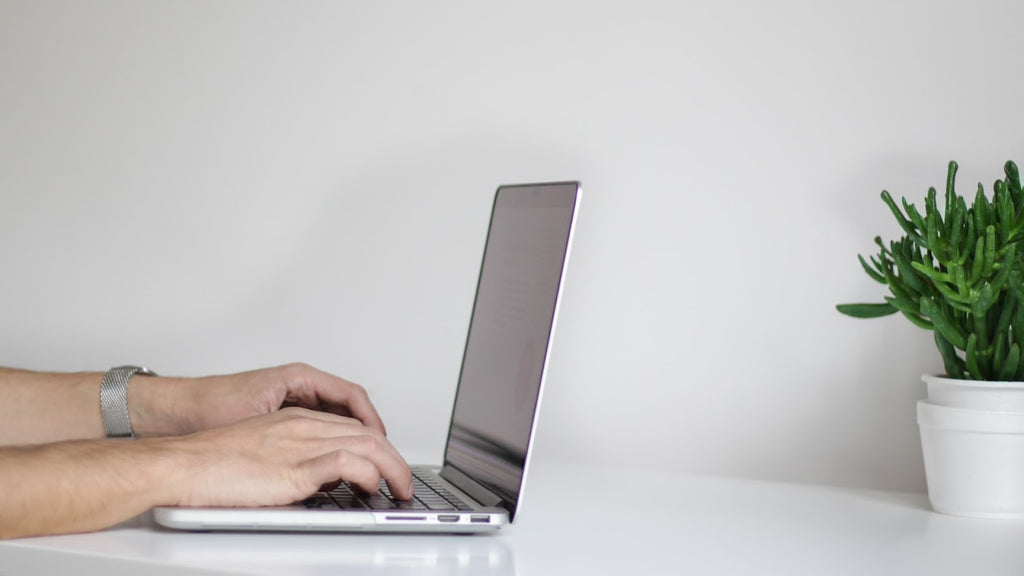 Hands typing on a keyboard