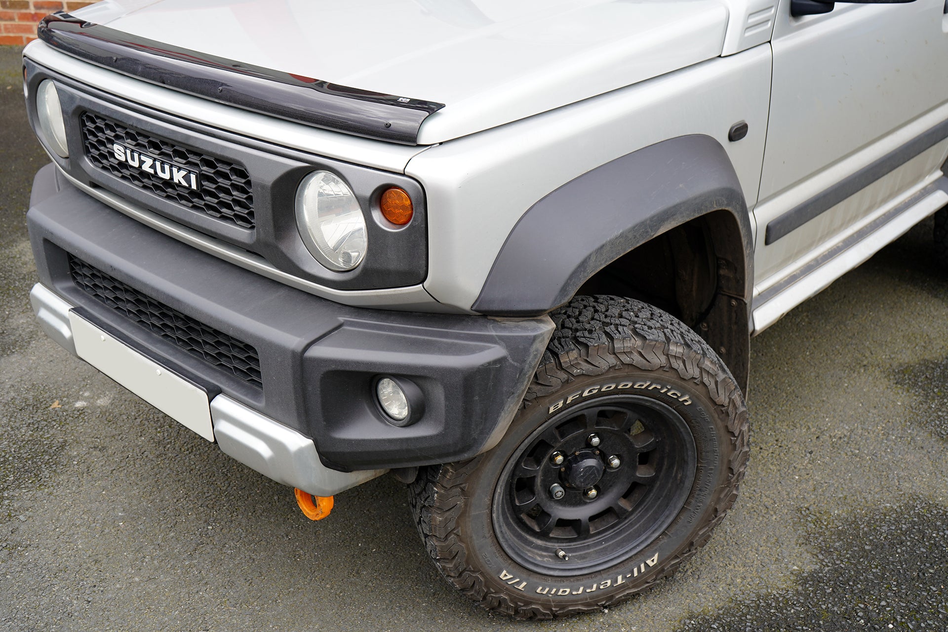 Suzuki Jimny with Bonnet Guard and J-01 High Peak Wheels Lifted Suspension and Front Runner Load Bars from Street Track Life JimnyStyle