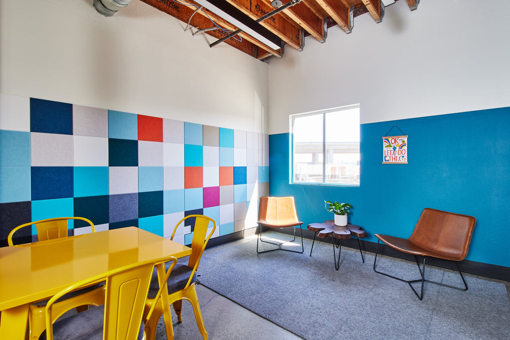Commercial interior design space with colorful square acoustic tiles on the wall.