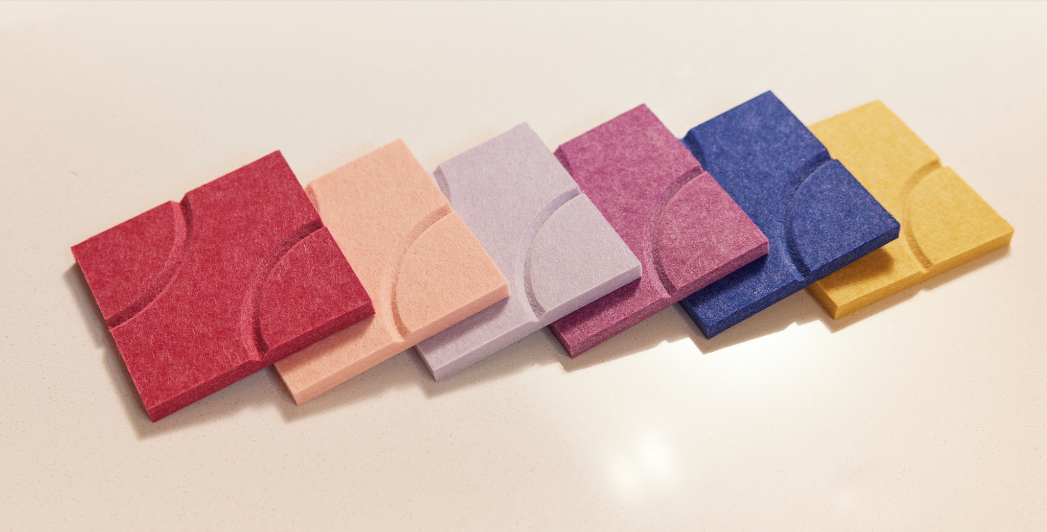 6 Felt Right coasters all in a line. Pink, purple, blue, and yellow coaster pack.