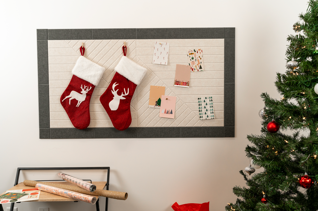 Christmas card display on the wall with cards and stockings pinned up.