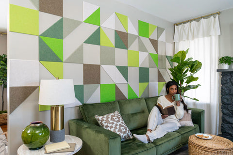woman relaxing next to green mid century modern felt wall tiles