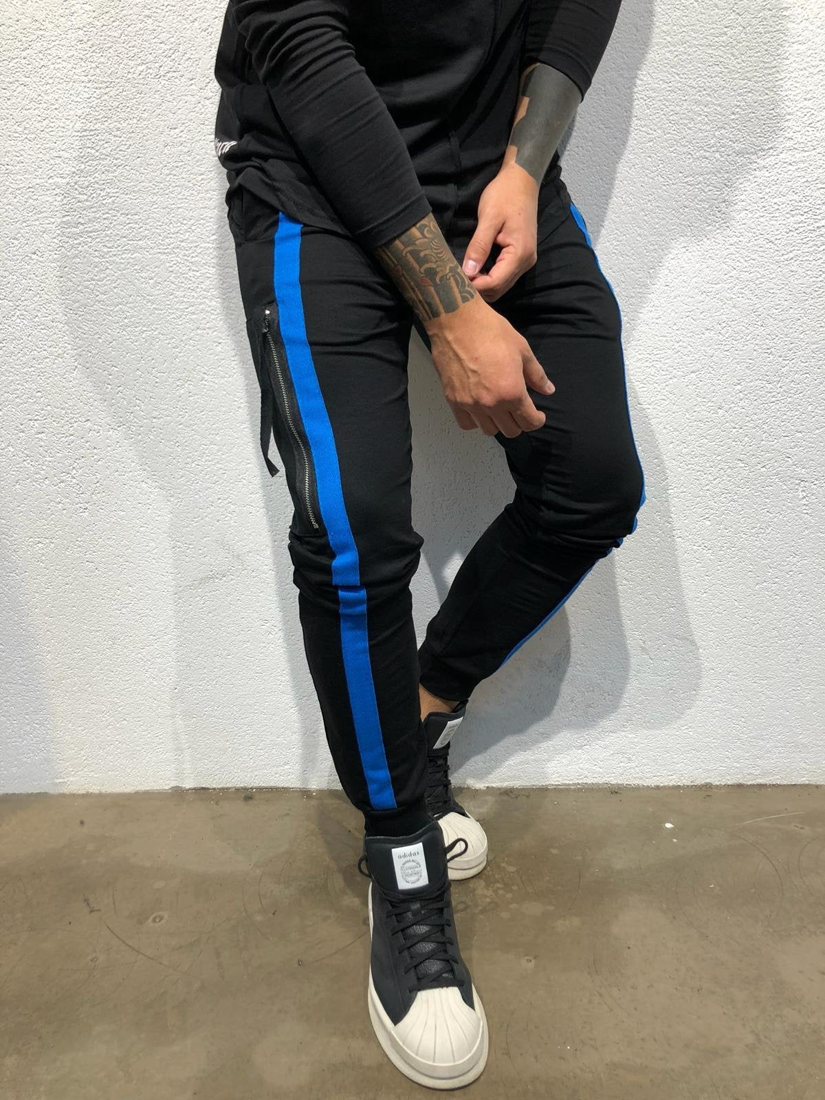 black joggers with blue stripe