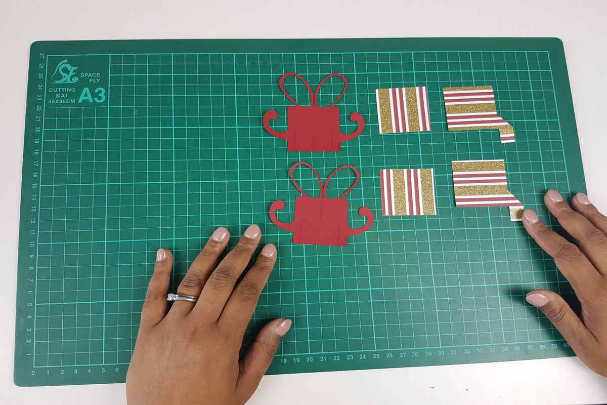 How To Make A Christmas Pop Up Card Tutorial - picture of all pieces cut out and arranged on cutting mat