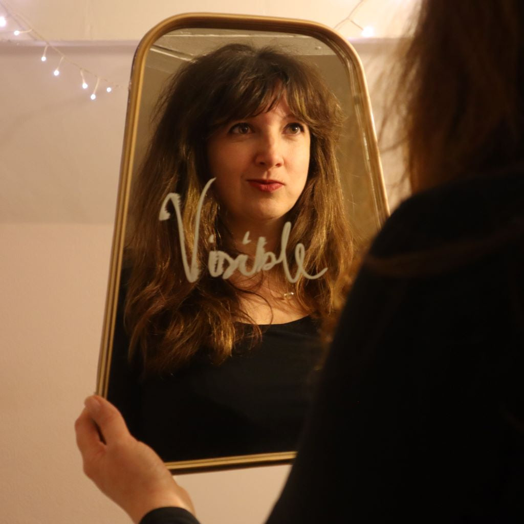 alt="Bex Massey's reflection in a mirror with her word for the year, visible written on it. Read about showing up and being seen, Brene Brown and visibility at Bramble and Fox UK hygge blog."