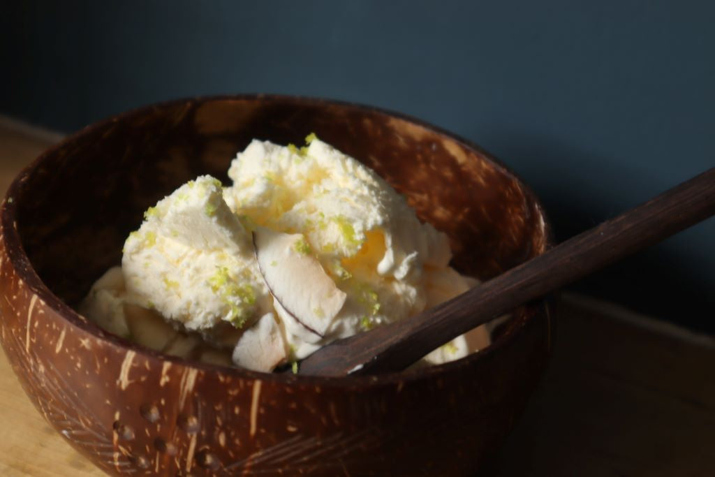 alt="no churn pina colada ice cream served in an organic coconut shell bowl. Recipe and bowls available from Bramble and Fox UK hygge gifts and homeware"