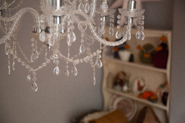 alt="ariel view of chandelier with cream dresser in background. Image available at Bramble and Fox UK hygge home blog"