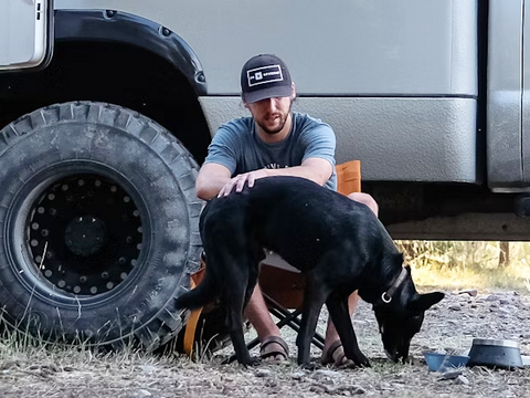 A man with his dog near the car