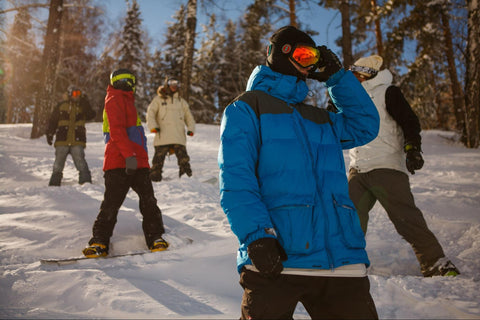 skiers and snowboarders staying warm with proper clothes