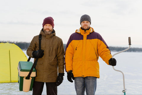 ice fishing hobbyists layering their clothes to keep warm 