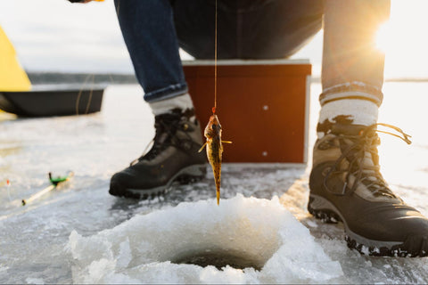 ice fishing enthusiast protecting his feet by wearing boots