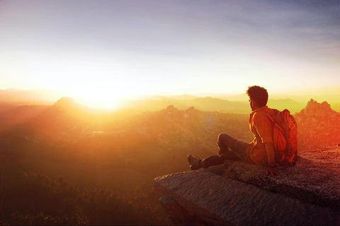 hiker resting and watching the sunset