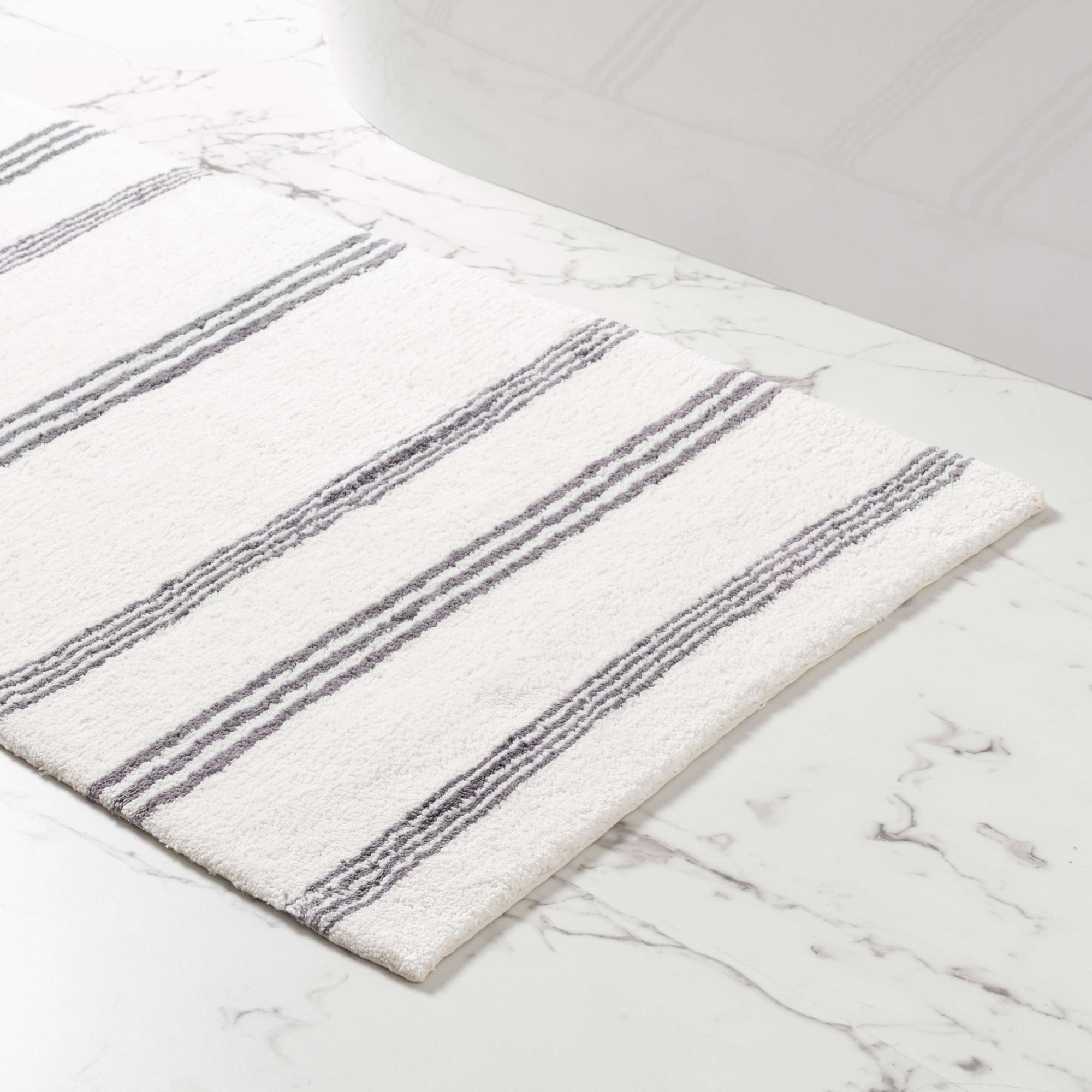 https://cdn.shopify.com/s/files/1/0091/7294/2912/products/Pine_Cone_Hill_Rowe_Stripe_Shale_Bath_Rug_4_2000x.jpg?v=1661709420