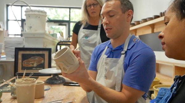 Paul from Fox 5 Good Day Atlanta getting pottery tips from Kim at AC Studios