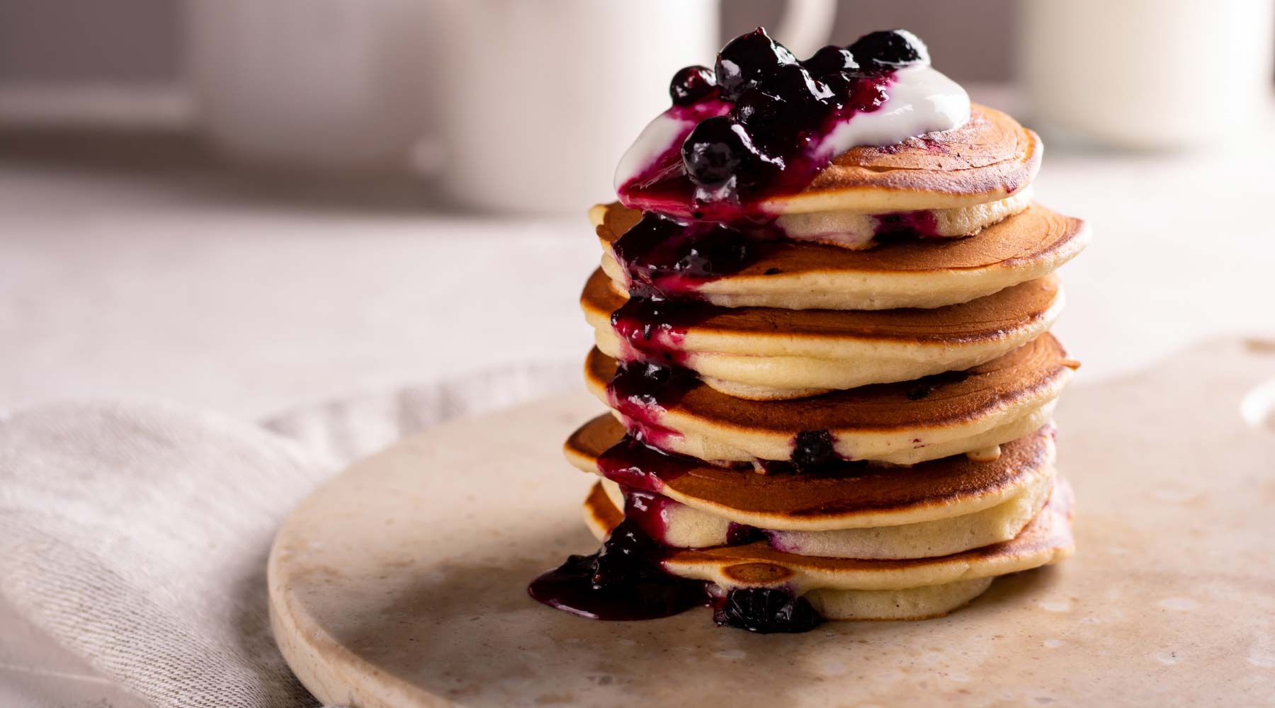 Pancakes tower covered with berry jam