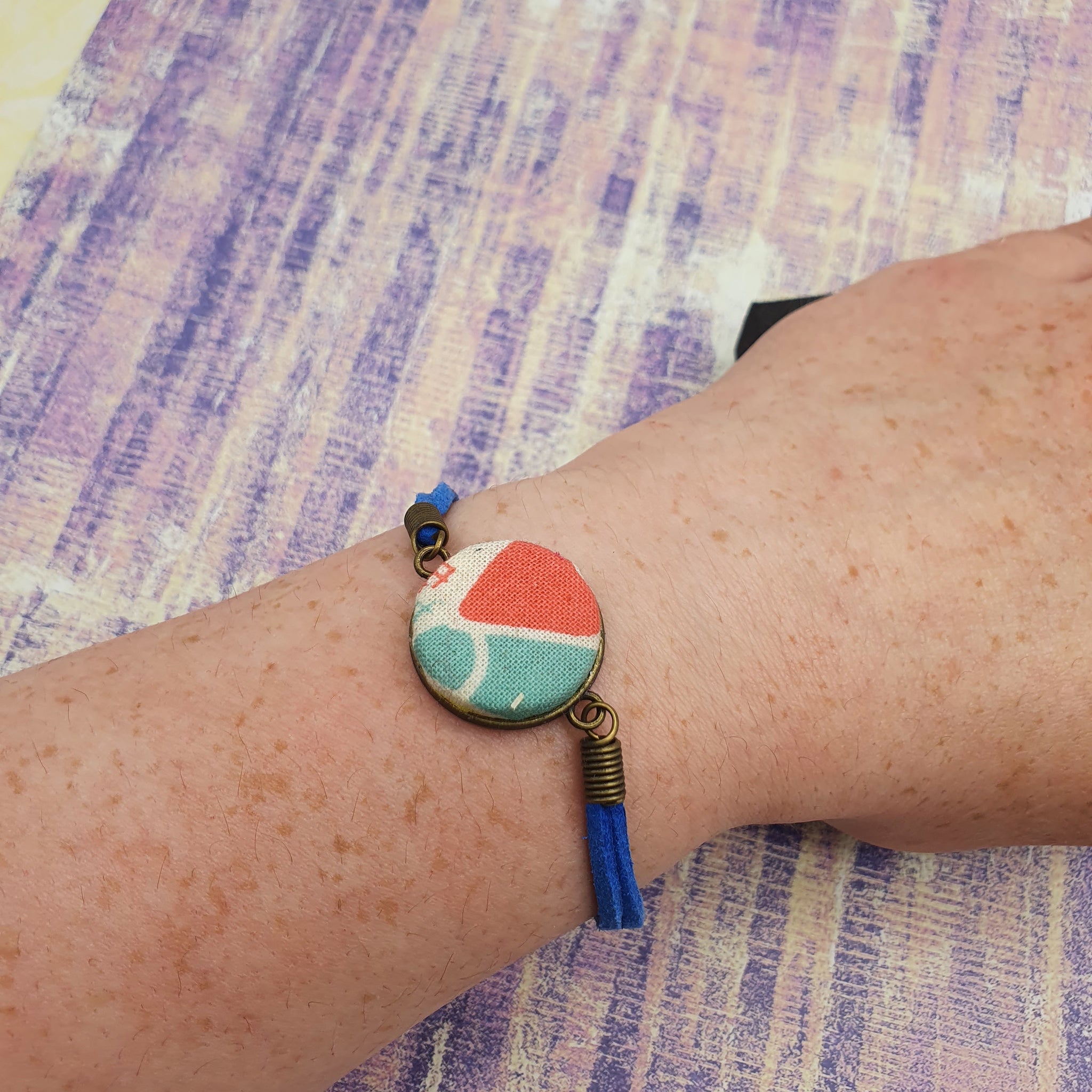 Blue and orange fabric bracelet.