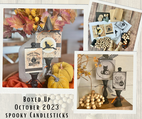 candle sticks topped with wooden blocks covered in spooky papers and a pumpkin made from wooden beads