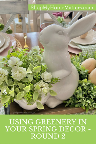 white ceramic bunny holding Irish Hops Half Sphere greenery with flowers