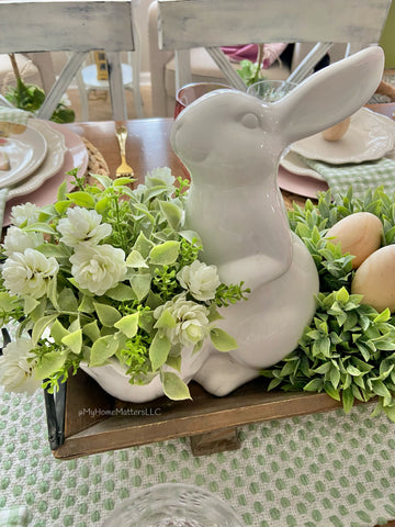 White ceramic bunny holding a basket filled with Irish Hops Half Sphere greenery