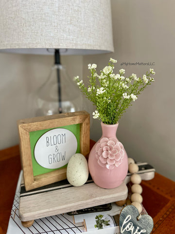 Pink and green Spring decor on a side table 