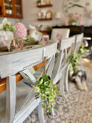 Wildflower Wishes faux green hung off the back of a kitchen chair