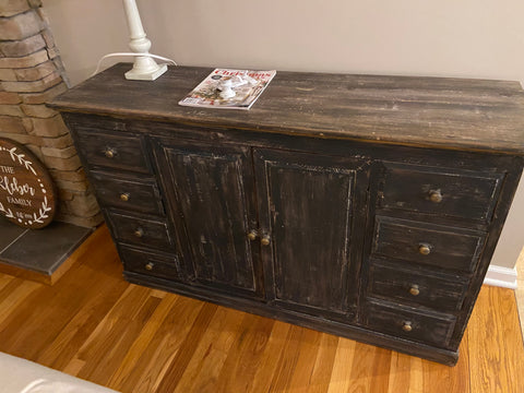 rustic black cabinet with light brown top on hardwood floor