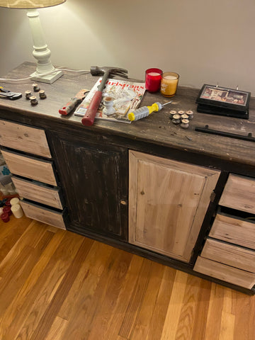 black cabinet partially sanded down to bare wood