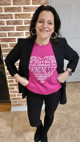 woman wearing berry colored kindness t-shirt with black leggings and black blazer