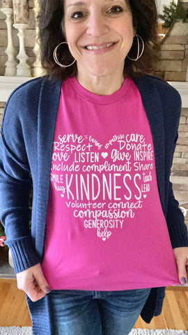 Dark haired woman wearing berry colored Kindness T-Shirt and navy cardigan