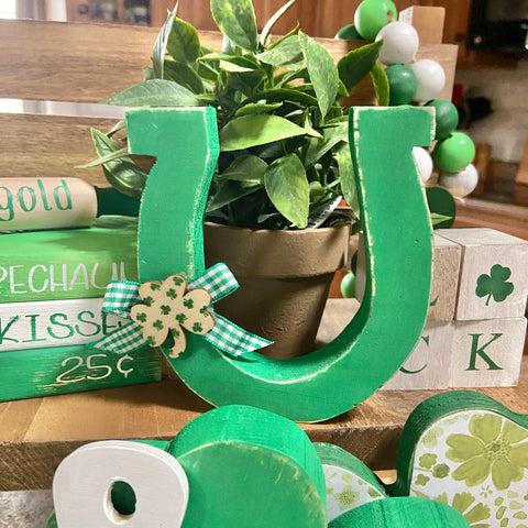 wooden horse shoe painted green with green gingham ribbon and small shamrock as embellishments