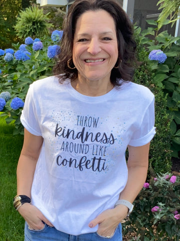 dark haired woman wearing t-shirt that says "Throw Kindness around like confetti."