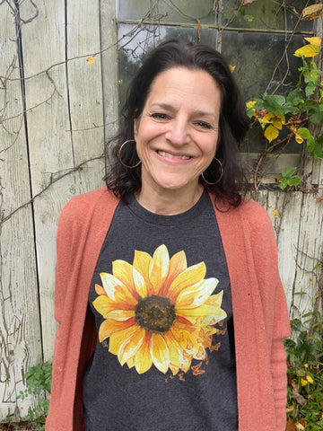 woman wearing sunflower t-shirt with an orange cardigan