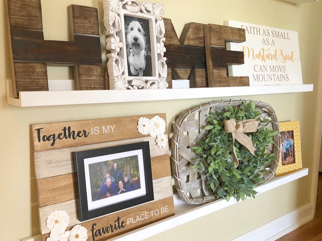 a gallery wall with home decor and family photos