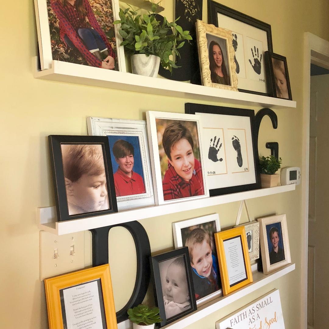 close up of a gallery wall with family photos