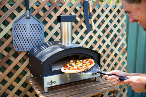 Launching-pizza-into-ovana-pizza-oven